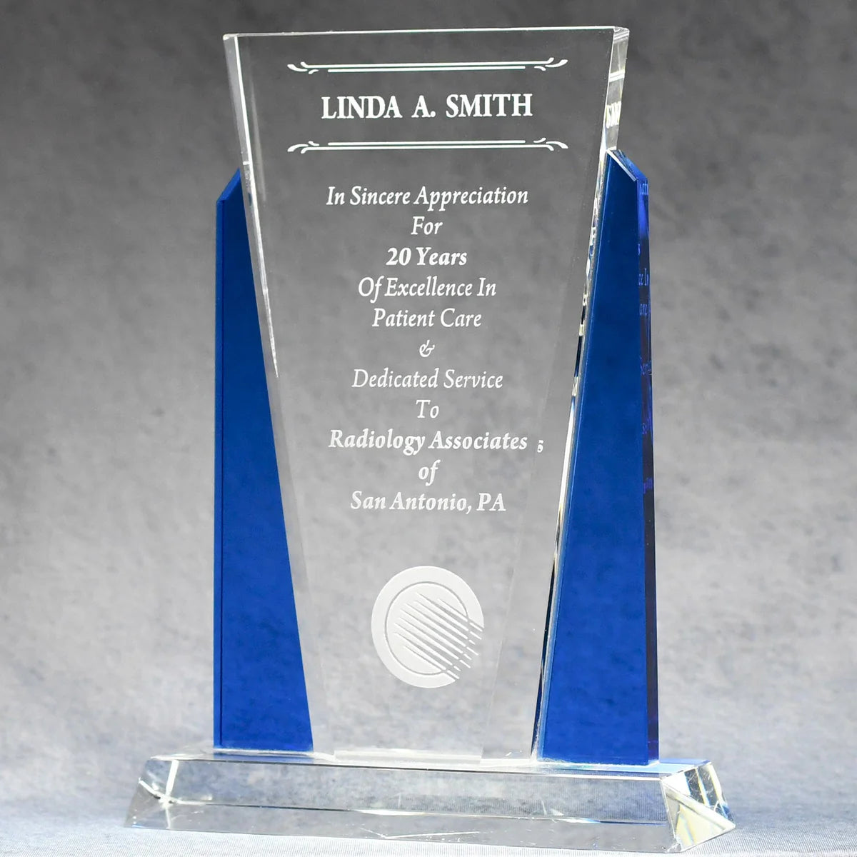 Optic crystal wit blue accents on each side with sand etch engraved logo and text personalization