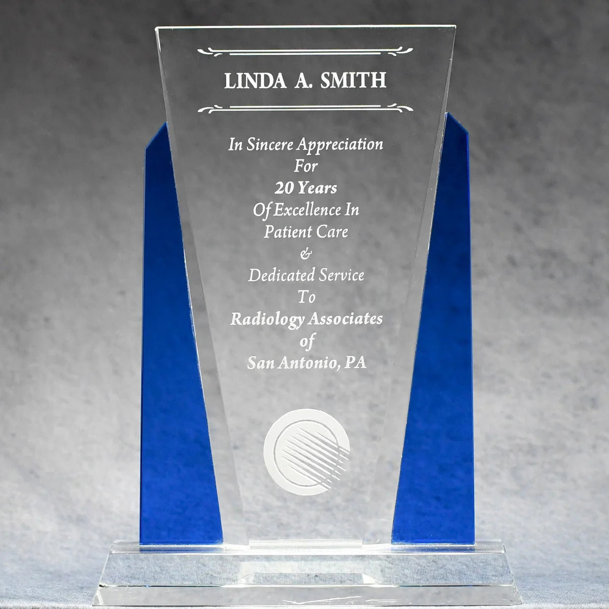 Optic crystal with blue accents on each side with sand etch engraved logo and text personalization