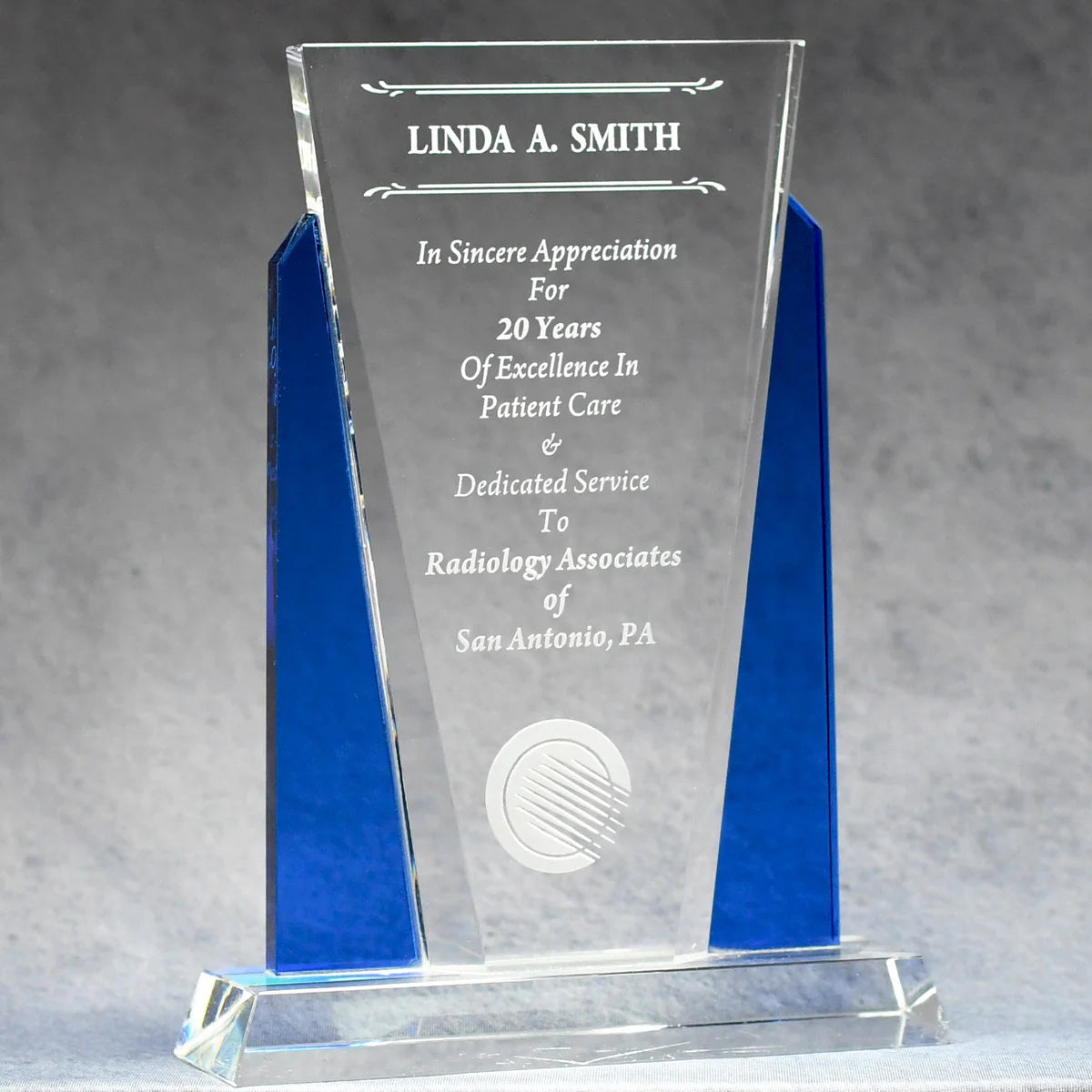 Optic crystal wit blue accents on each side with sand etch engraved logo and text personalization