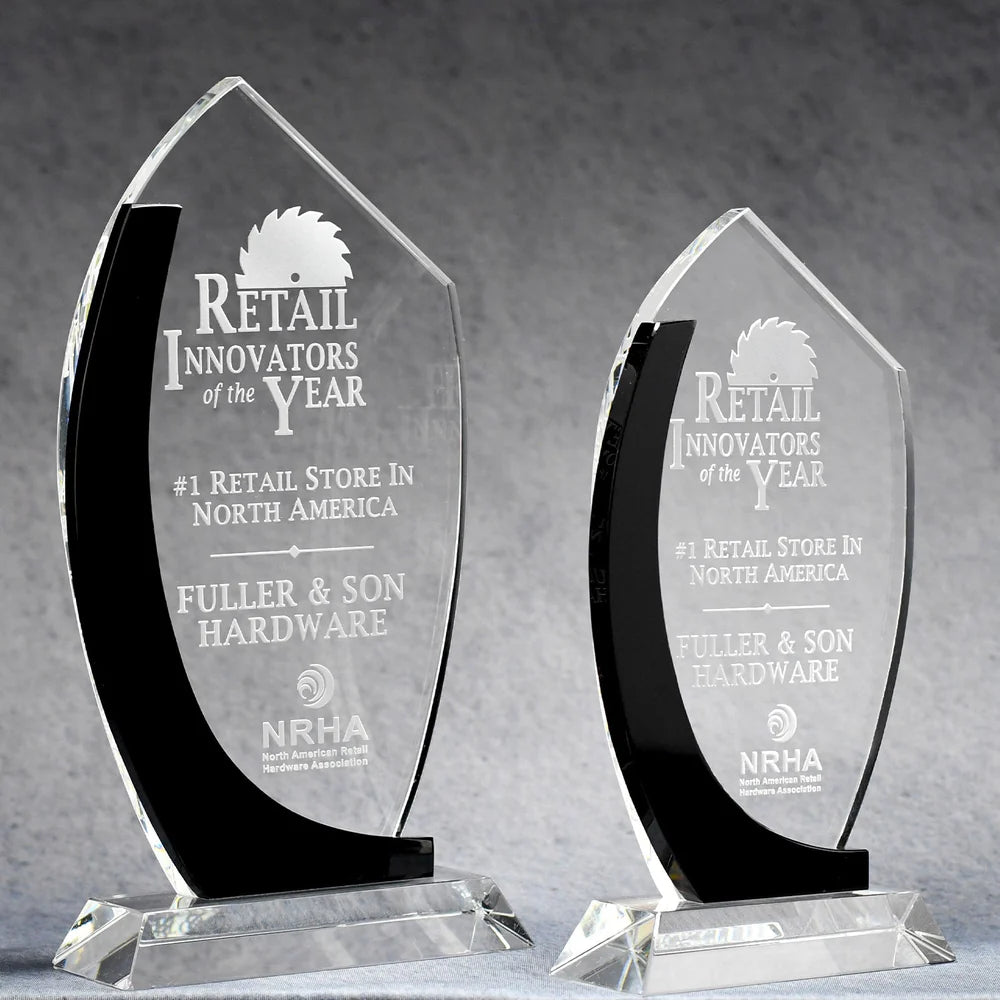 Crystal awards with black accent clear upper portions, featuring sand etch engraved text and logos recognizing achievements.