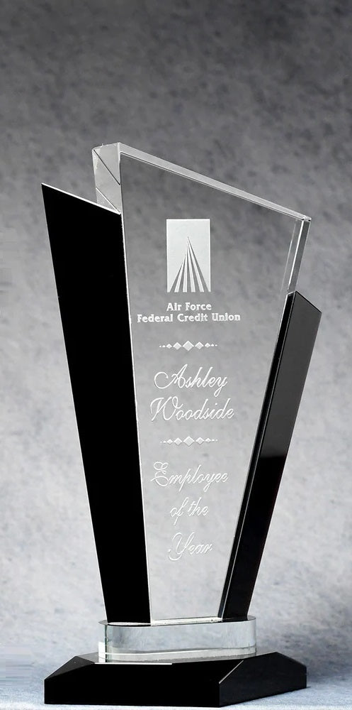 Crystal Tuxedo award with black accents and sand etched text, placed on a grey surface.