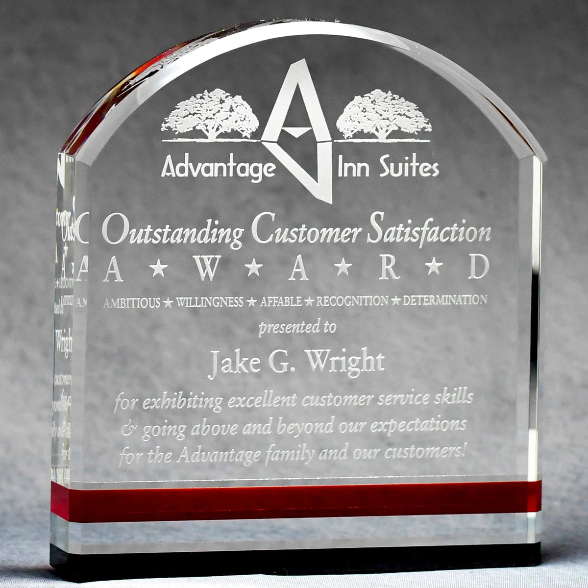 Clear crystal award with arched top, sand-etched engraving, red accent stripe, and black base design.