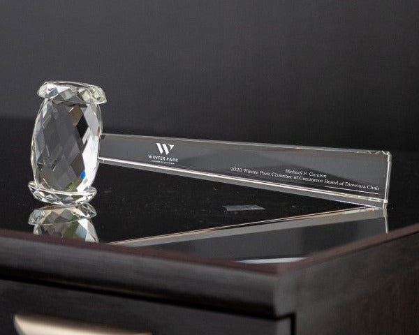Crystal award on a black surface with a dark background