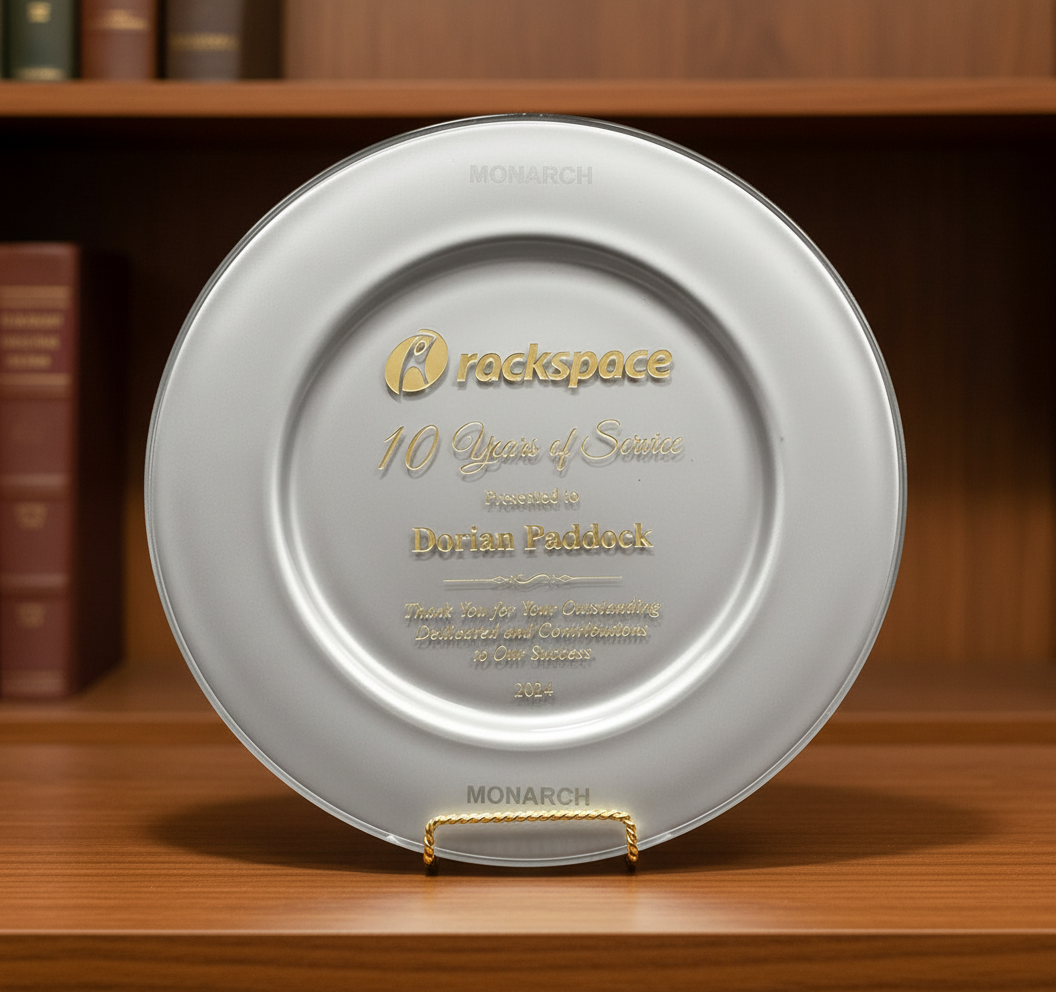 Silver plaque with engraved text on a wooden surface