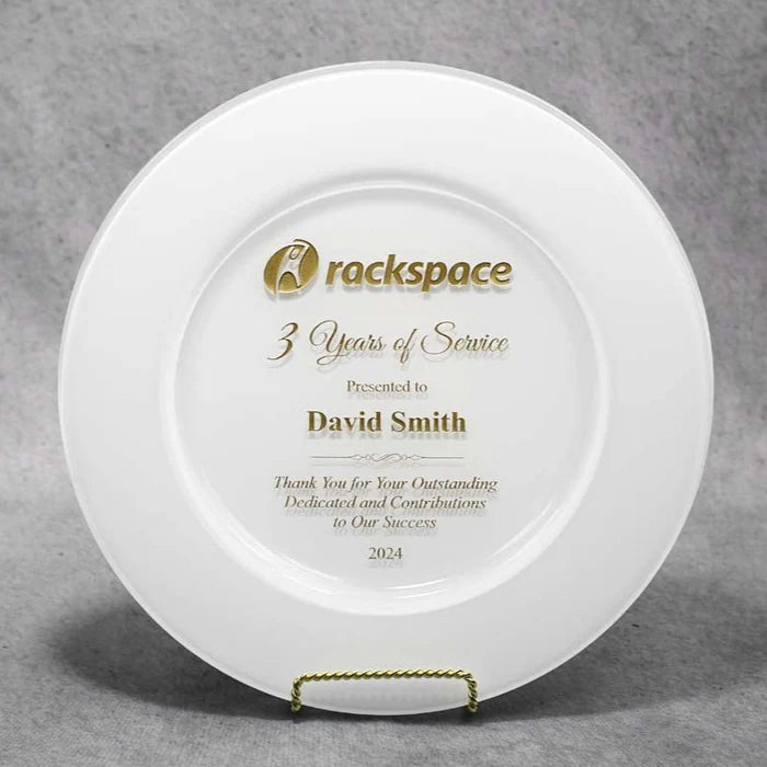 A white glass plate with gold and silver text, presented on a stand, celebrating 3 years of service to David Smith.