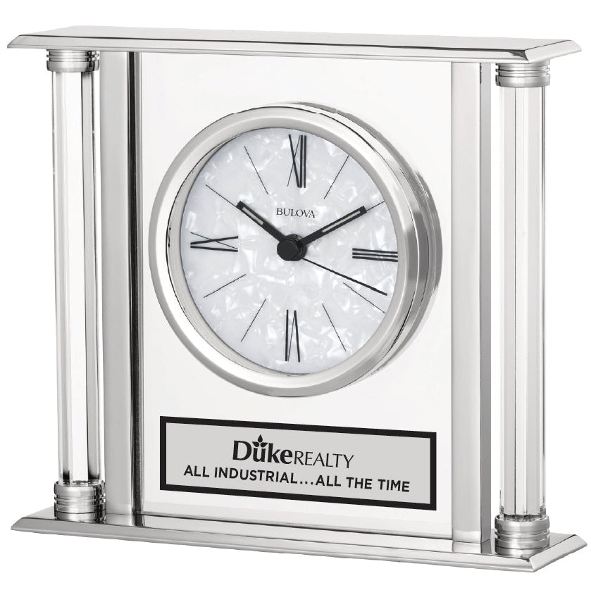 Silver clock with Dike Realty logo on a white background