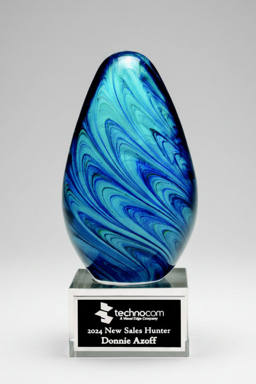 Blue and green marbled glass award with a Technocom plaque on a white background