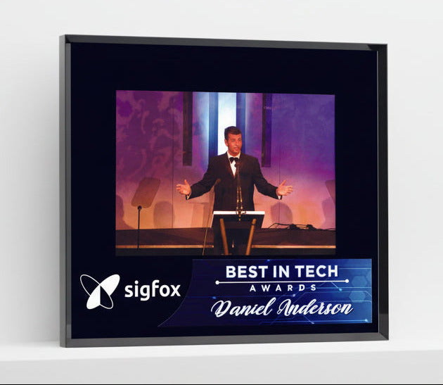 Framed award for 'Best in Tech' with a person on stage and Sigfox logo.