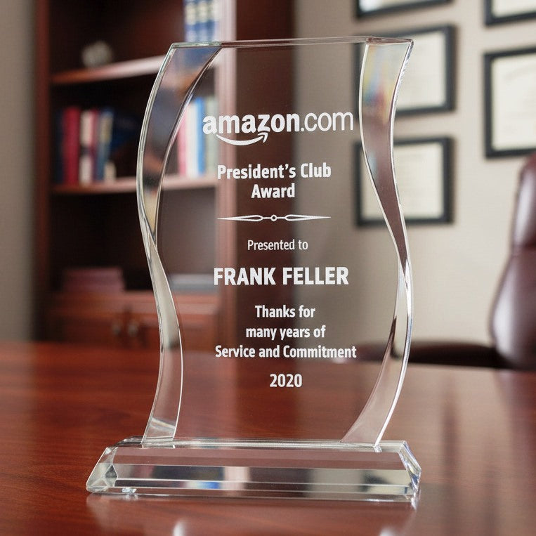 A clear acrylic award Deal Toy, featuring engraved text and corporate logo.
