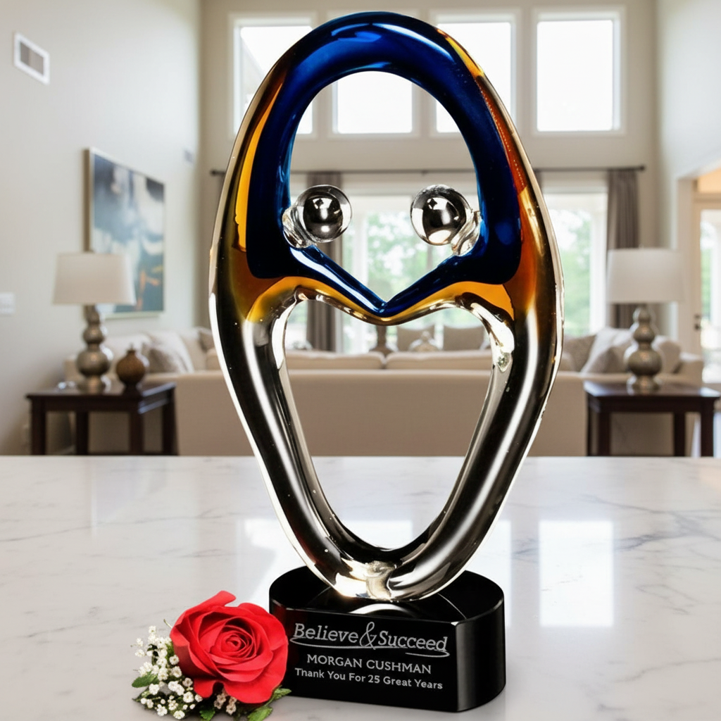 Art glass sculpture with 'Believe & Succeed' message sand etched and color filled on a marble base