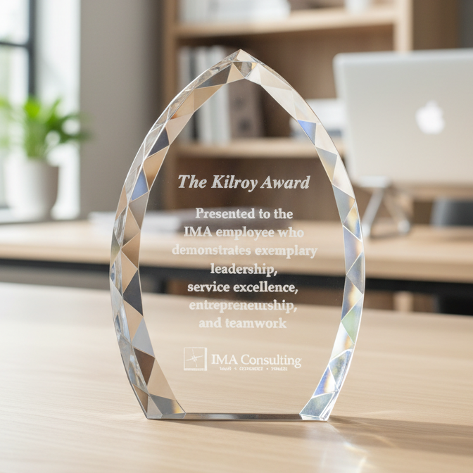 Crystal award on a desk with a blurred office background