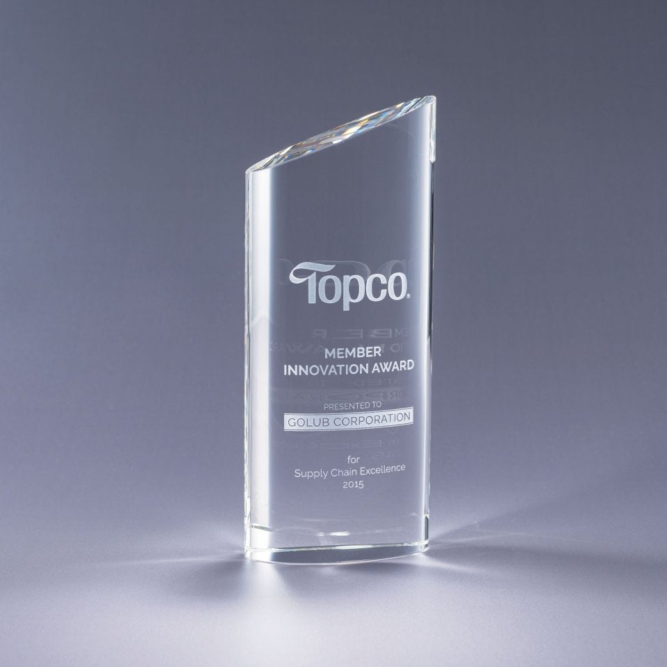 Clear glass award with Sand etch engraved text and logo on a gray background
