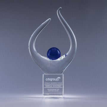 Clear glass award with blue sphere on a crystal base with gray background