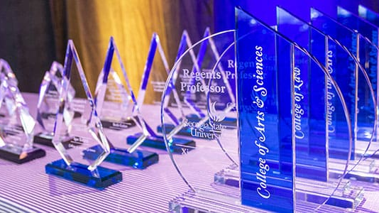 Academic award presentation on a table with a blurred background