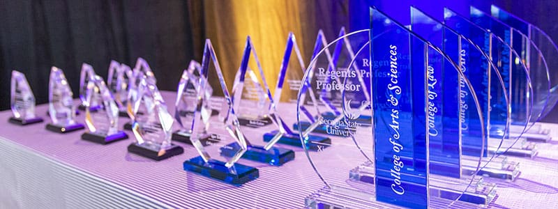 Multiple Optic crystal sphere with inset blue tower awards decorated with sand etch engraved logo and text