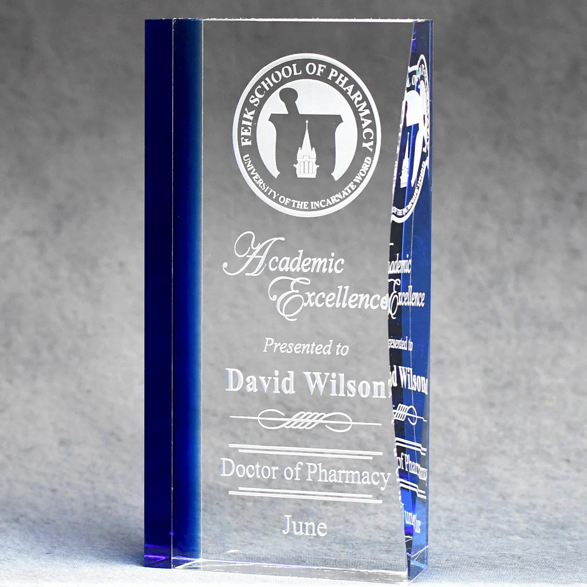 Elegant optic crystal award with blue tint along left side, logo and text sand etched and color filled white