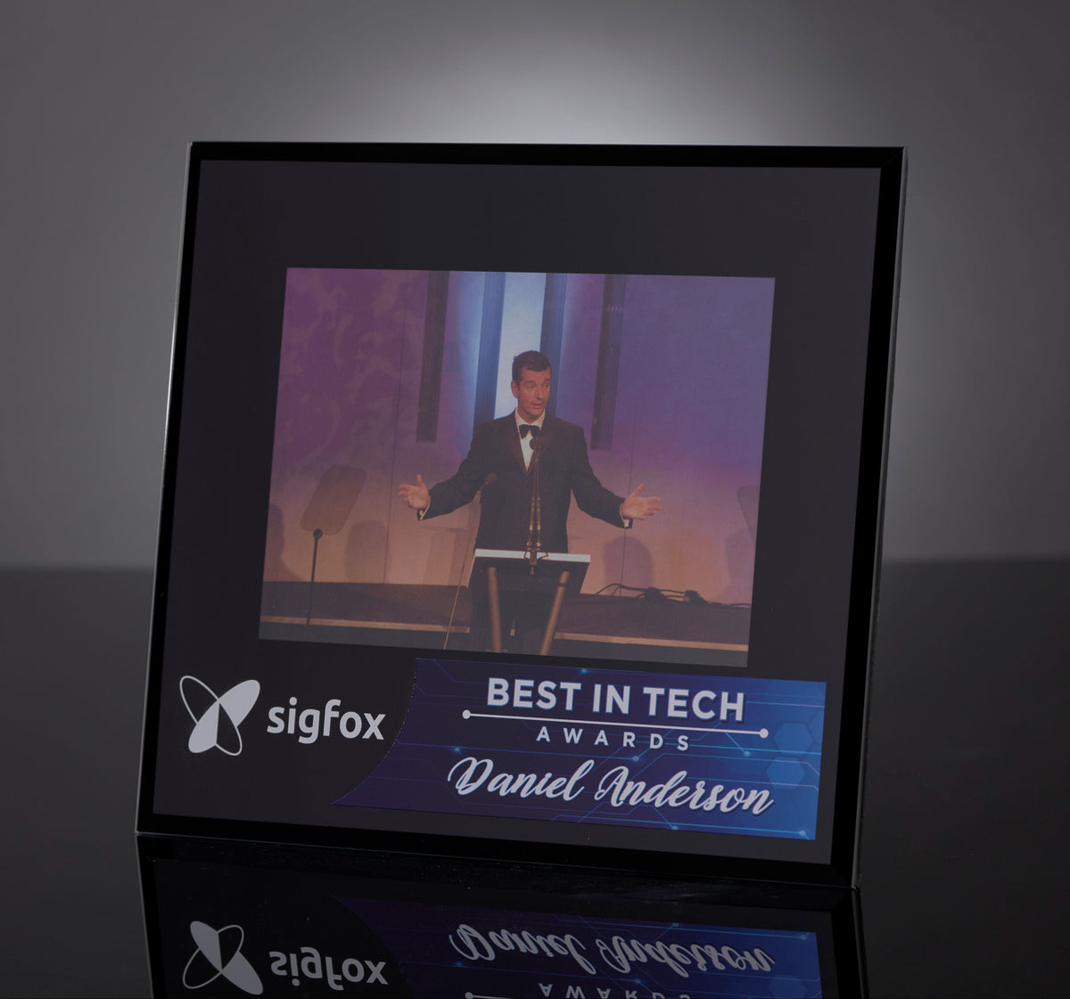 Framed picture of a man on stage with 'Best in Tech Awards' text and Sigfox logo.