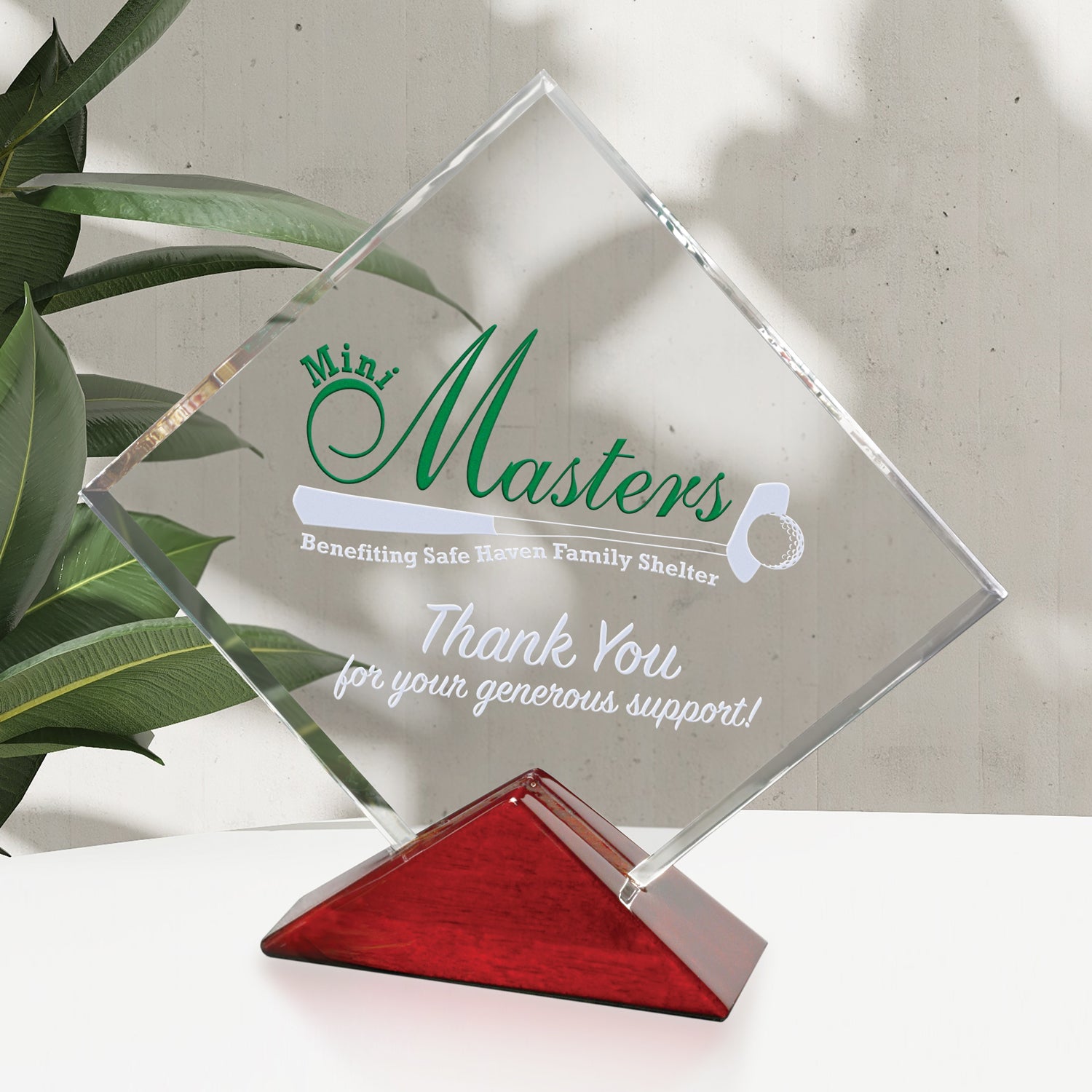 A square optical crystal award with UV color engraved text and logo on a piano finished base,