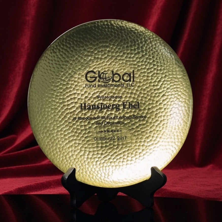 Decorative plate with engraved text on a red fabric background