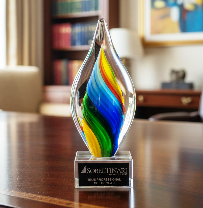 Colorful glass award on a desk with blurred office background