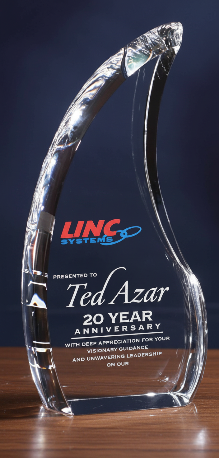 Crystal award with logo and text on a dark background