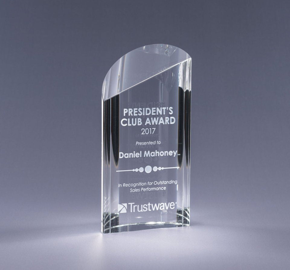Clear glass award with 'President's Club Award 2017' sand etch text and logo on a gray background