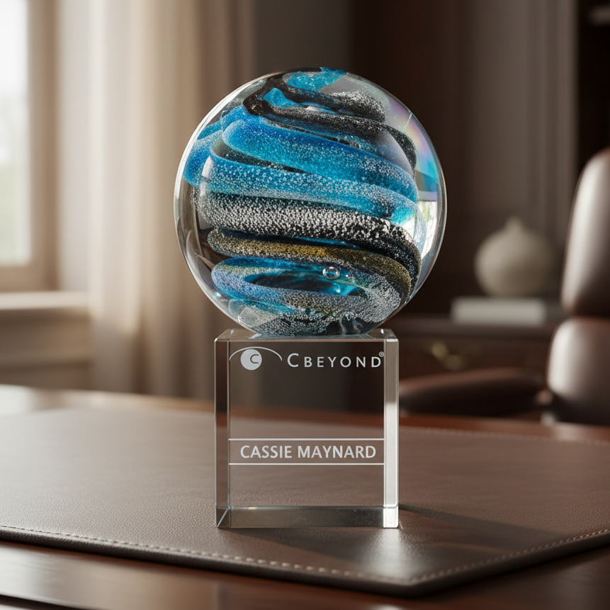 Decorative art glass sphere with corporate logo and text engraved on the base.