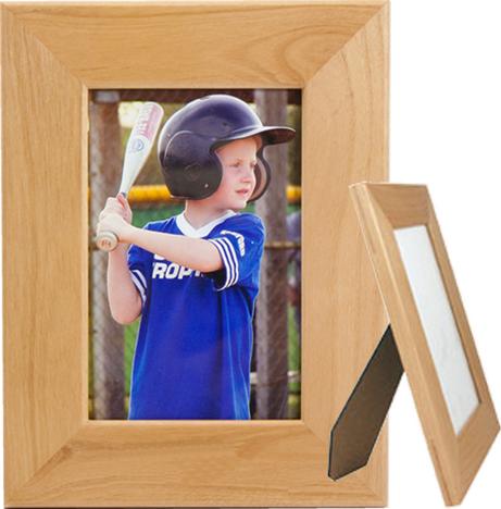 A wooden frame with a glass panel and easel back, displaying a photo of a young baseball player in a blue and white uniform, holding a baseball bat.
