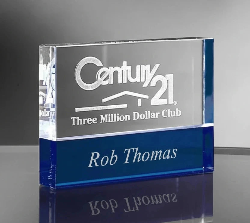 Glass award with Century 21 logo and 'Three Million Dollar Club' text on a gray background