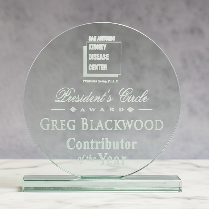 jade Glass award with engraved text on a gray background