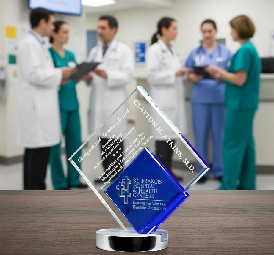 Crystal Glass award with 'St. Francis Hospital & Health Centers' on a wooden surface, with healthcare professionals in the background.