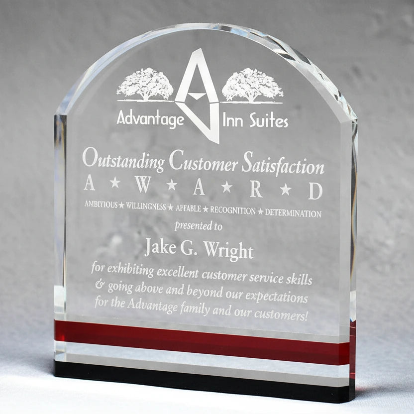 A clear crystal award with black and red accents, featuring text that acknowledges an outstanding contribution or performance.