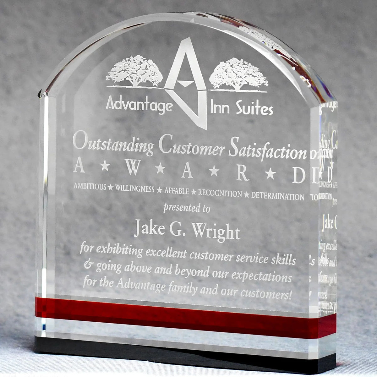 Clear crystal award with arched top, sand-etched engraving, red accent stripe, and black base design.