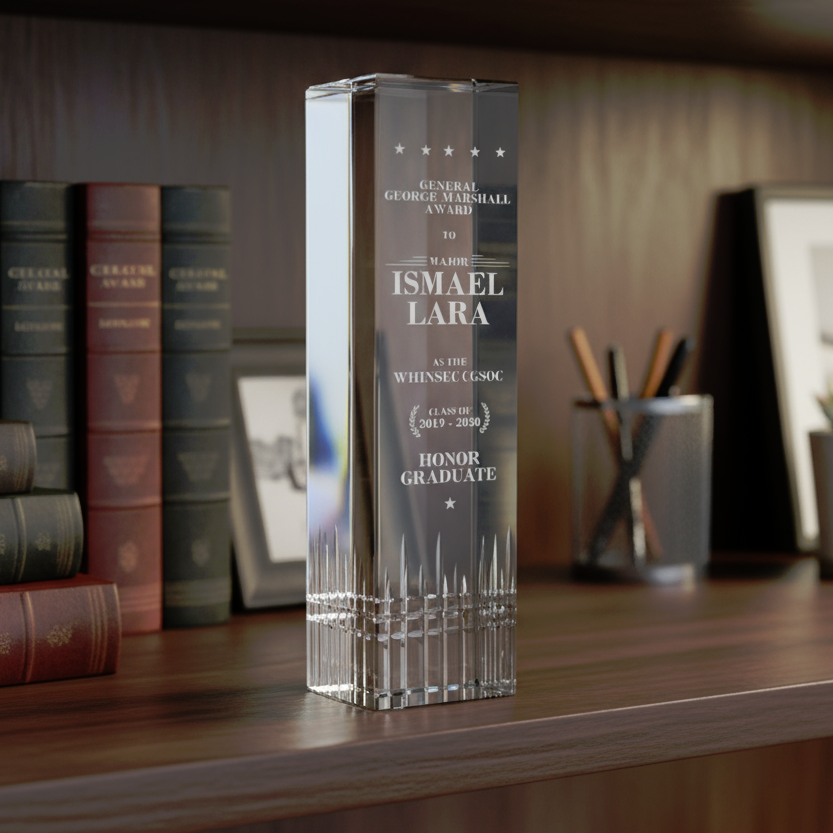 8.5" tall crystal award with legible engraved text on an office desk