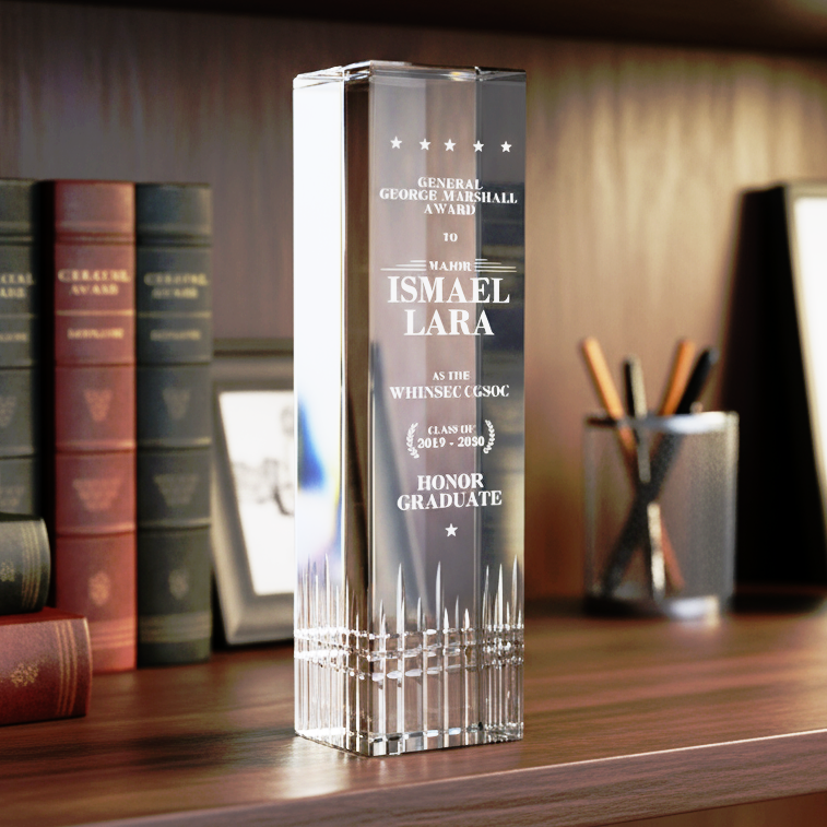 Crystal award on a shelf with books and decorative items in the background