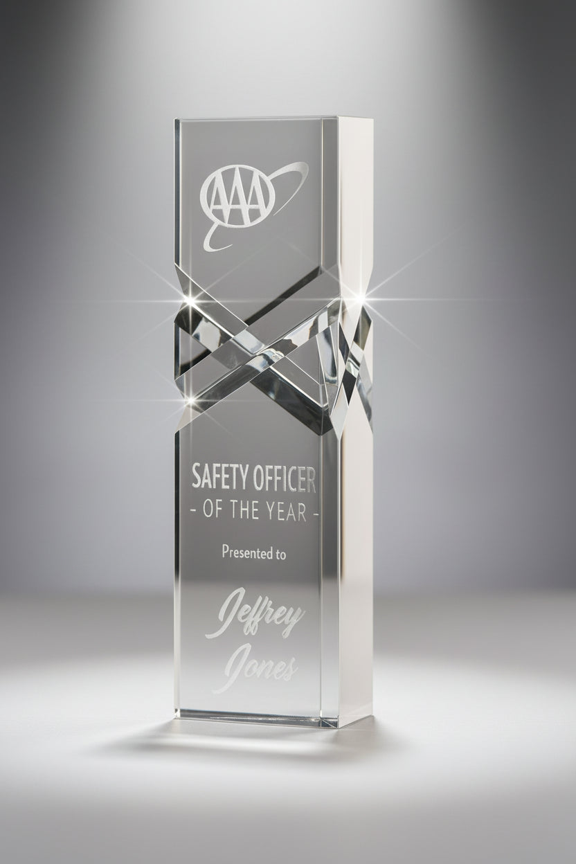 Crystal award with engraved text on a gray background