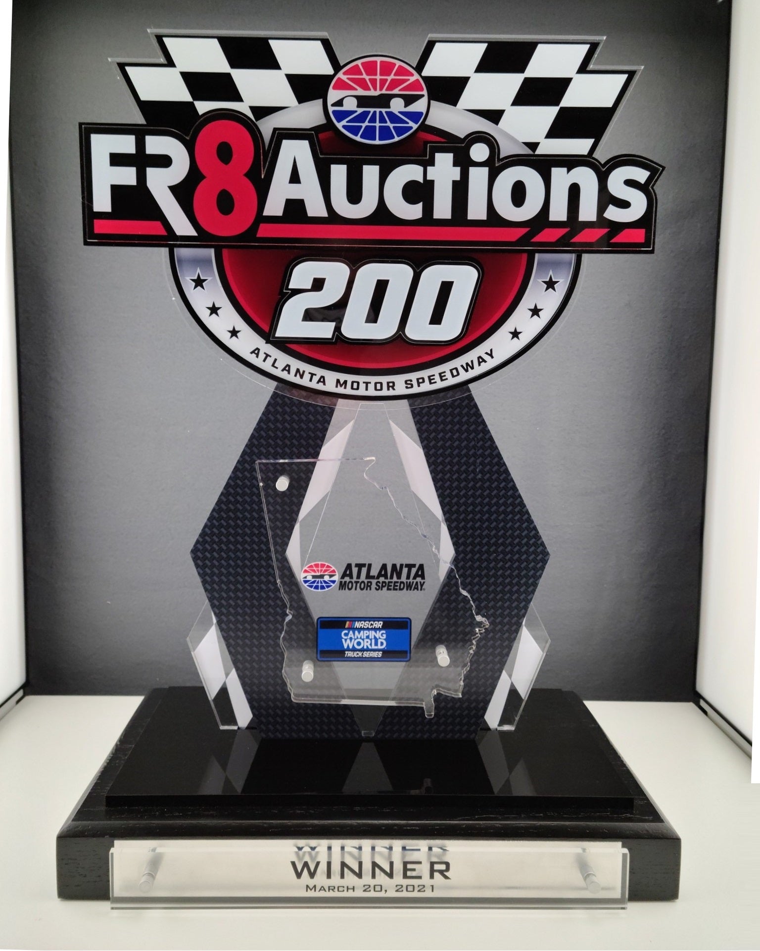 Awards trophy with 'FR8 Auctions 200' and Atlanta Motor Speedway branding on a black background.