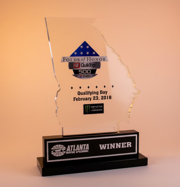 Awards trophy with multiple logos on a white background