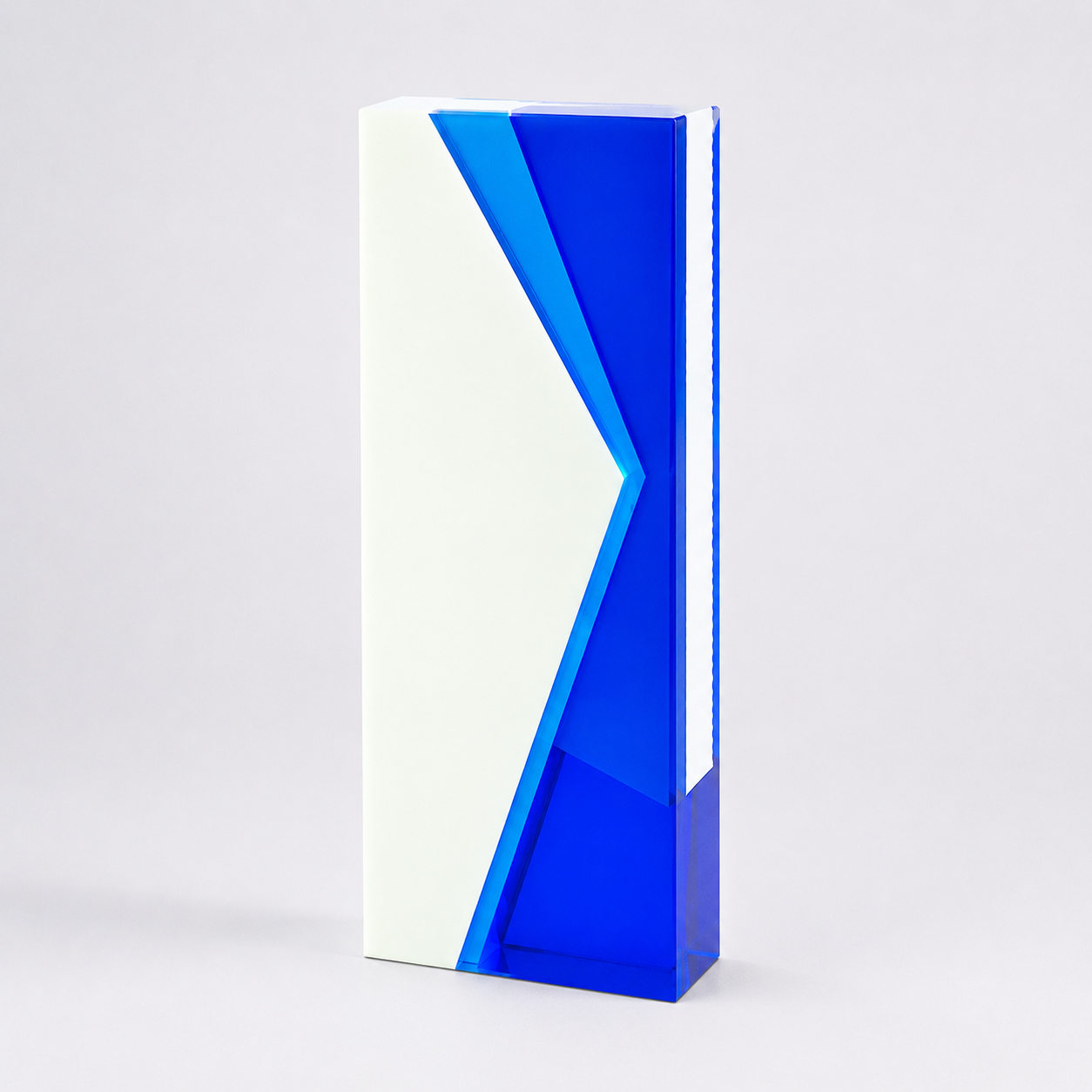 Tall, blue and white geometric sculpture on a light gray background