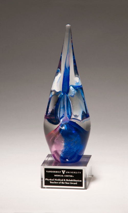 Blue and violet art glass award on clear glass base. Laser engravable aluminum plate.