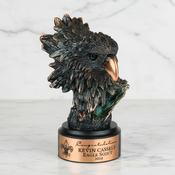 Bronze eagle head sculpture on a marble base with engraved text