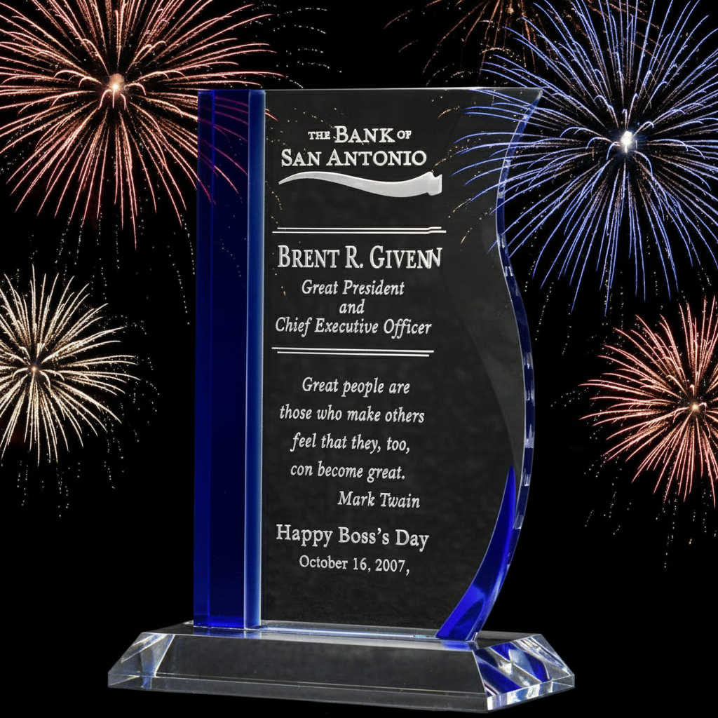 Crystal award with blue accents and engraved text against a fireworks background