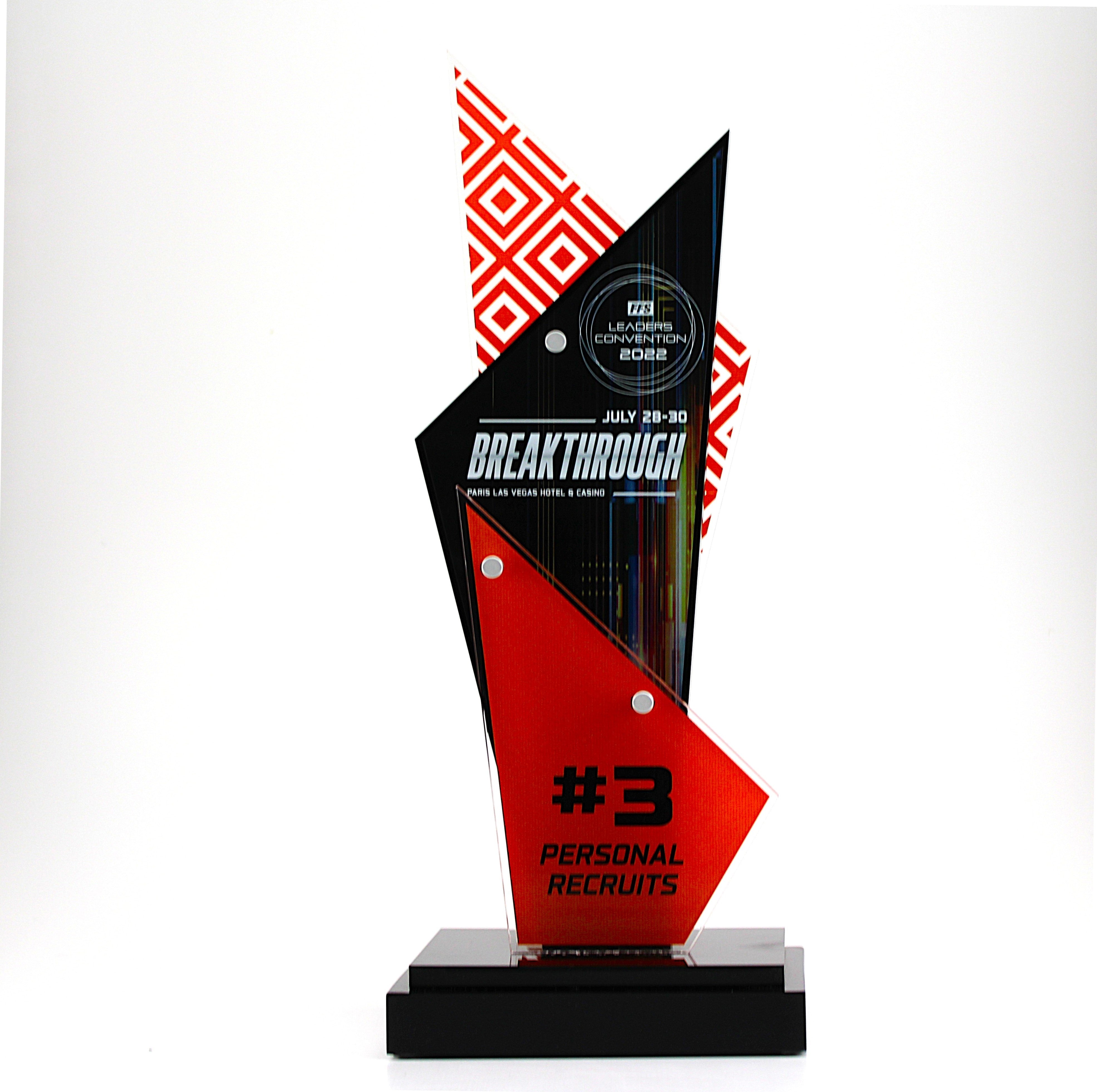 A custom Lucite trophy award with geometric design and engraved text. Ideal Deal Toy or Tombstone.