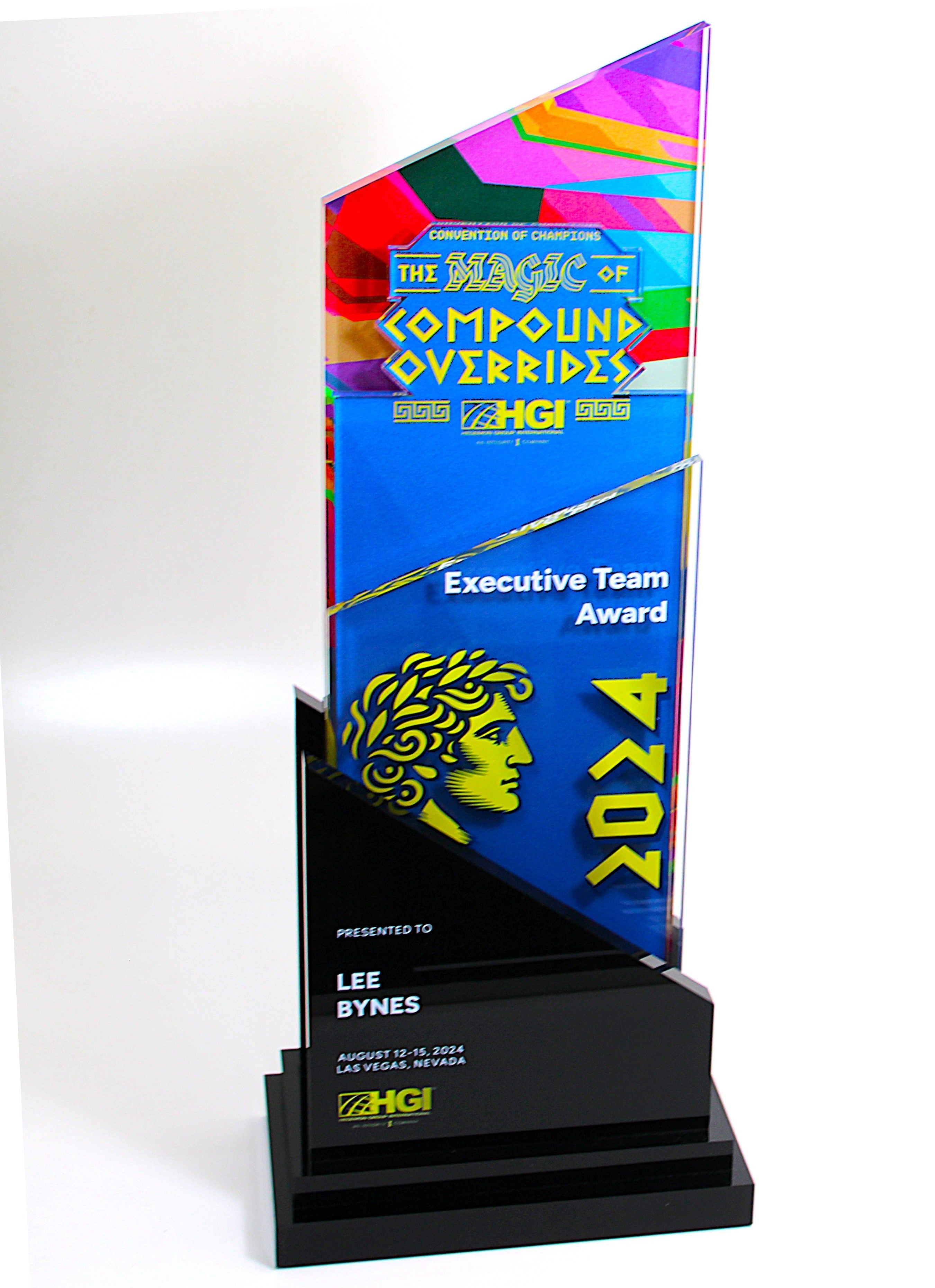 A custom acrylic beacon award with a colorful geometric design, a black base, and personalized text.