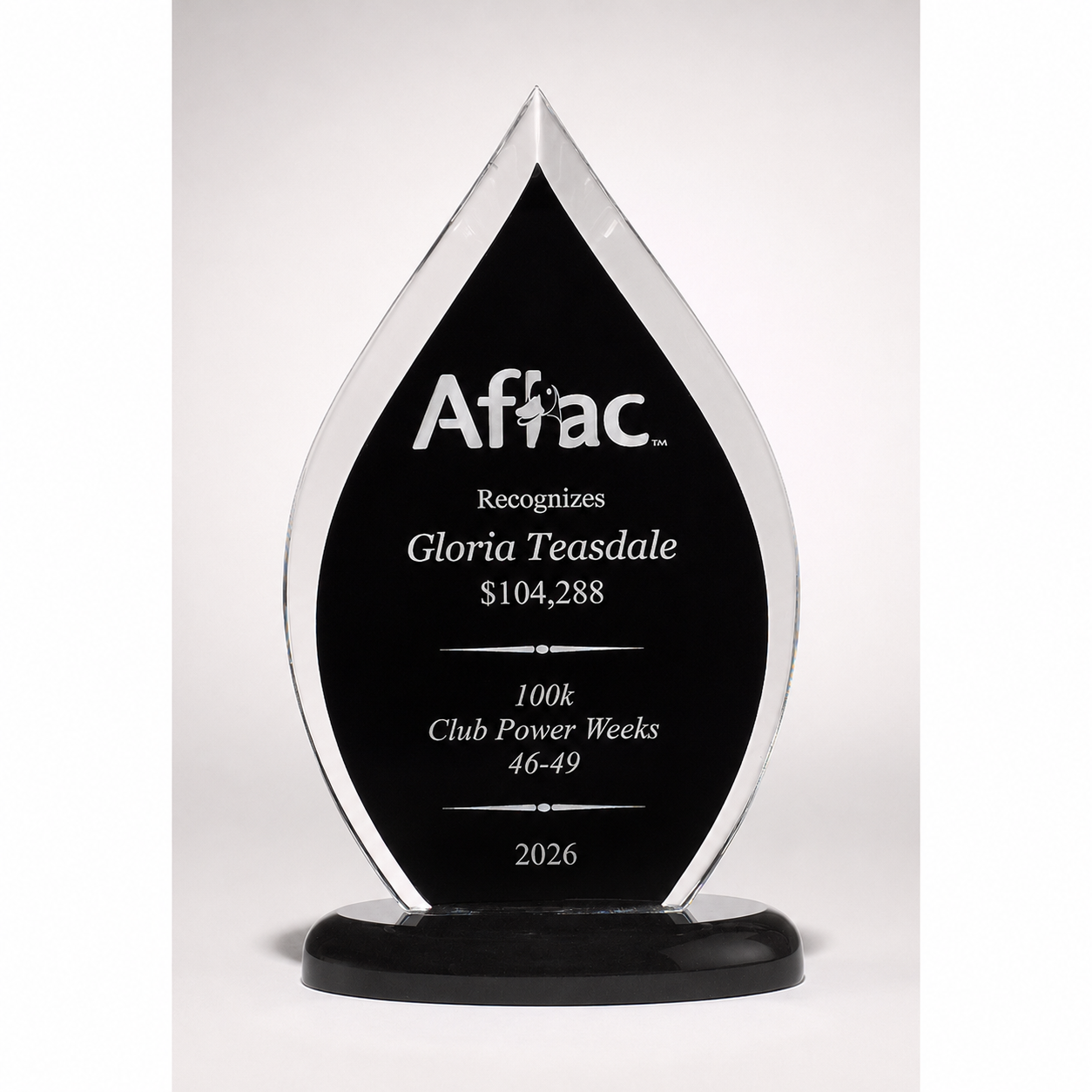 Aflac award with engraved text on a white background