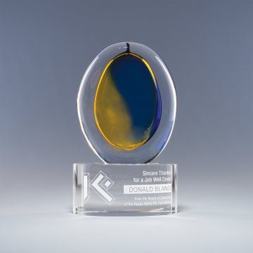 Art glass swirls and patterns of suspended air bubbles on crystal base with etched text 