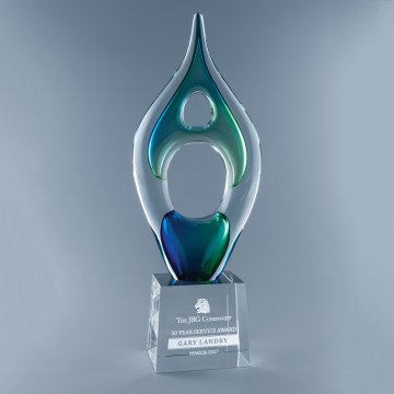 Abstract art glass award with blue green hues on crystal base with sand etched text and corporate logo