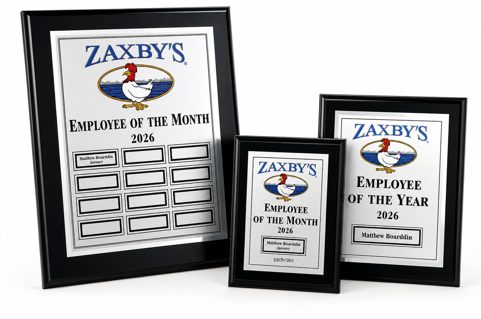 Employee of the Month and Employee of the Year awards on black plaques.