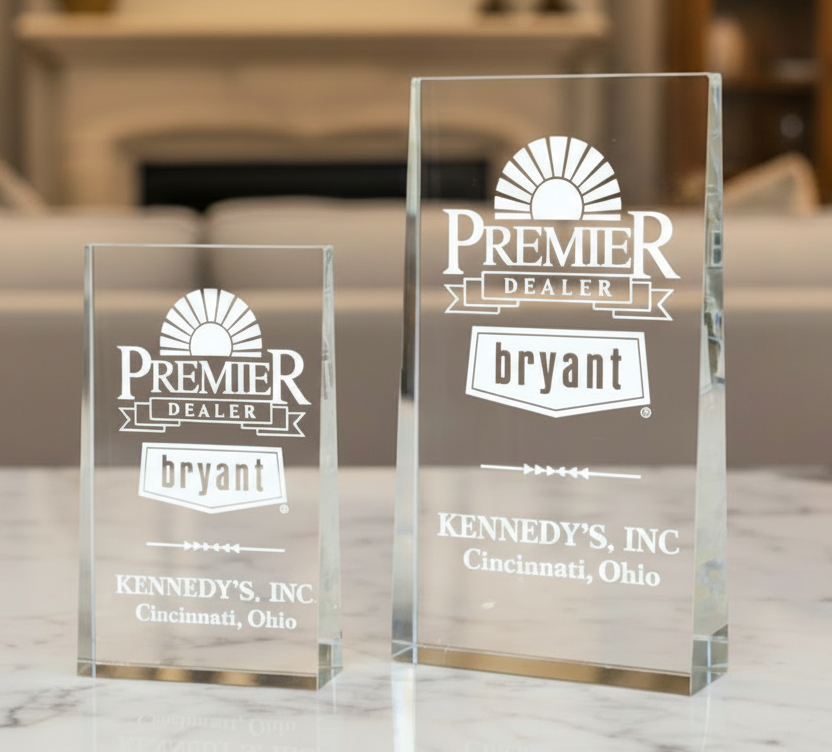 OPTIC CRYSTAL WEDGE awards with logo branding on a marble surface.