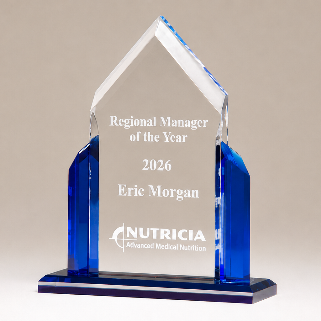 Acrylic award with blue base and clear top, engraved with 'Regional Manager of the Year 2026 Eric Morgan' and 'Nutricia'.